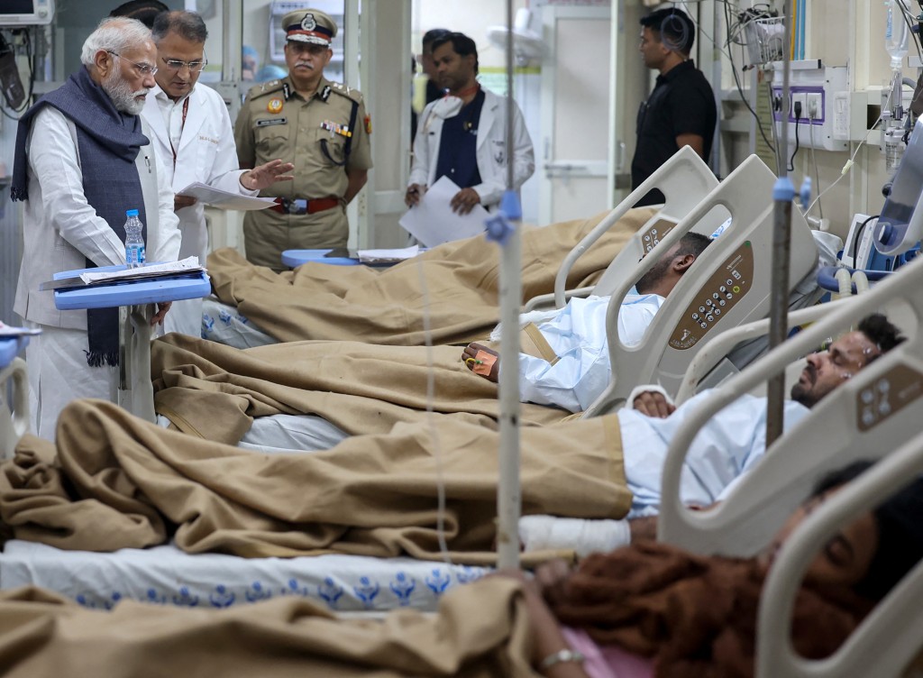 Photo by - / INDIAN PRESS INFORMATION BUREAU (PIB) / AFP  This handout photograph taken on November 12, 2025 and released by the Indian Press Information Bureau (PIB) shows India's Prime Minister Narendra Modi visiting the victims injured in an explosion near the Red Fort, at Lok Nayak Hospital in New Delhi.