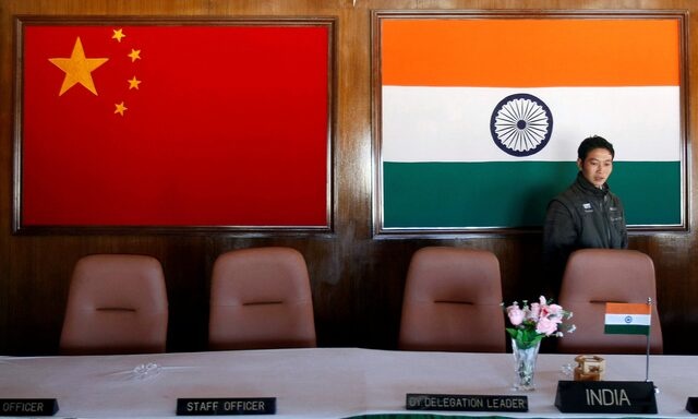 A man walks inside a conference room used for meetings between military commanders of China and India, at the Indian side of the Indo-China border at Bumla, in the northeastern Indian state of Arunachal Pradesh, November 11, 2009. REUTERS/Adnan Abidi/File Photo