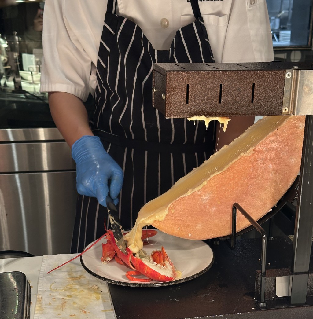 The raclette cheese station serving freshly steamed lobster.