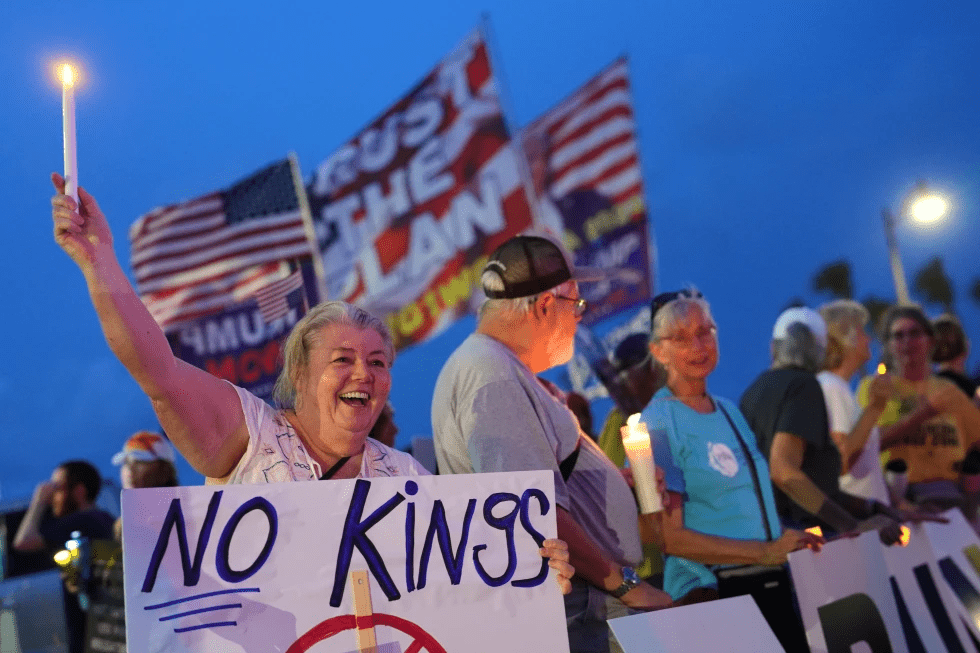 Dee Cahill of Margate, Fla., holds a “No Kings” sign as she participates in a pro-democracy, anti-Trump protest outside Trump’s Mar-a-Lago estate in Palm Beach, Fla., Thursday, July 17, 2025. (AP Photo/Rebecca Blackwell, File)