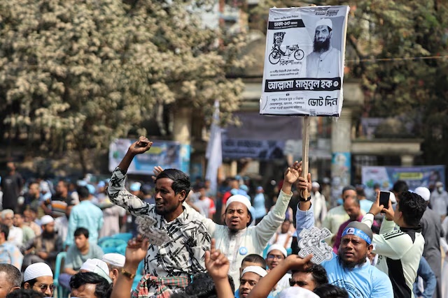 People chant slogans during an election campaign rally for candidate Mamunul Haque, head of the Bangladesh Khelafat Majlis, ahead of the national election, in Mohammadpur area, in Dhaka, Bangladesh, February 9, 2026. REUTERS/Mohammad Ponir Hossain
