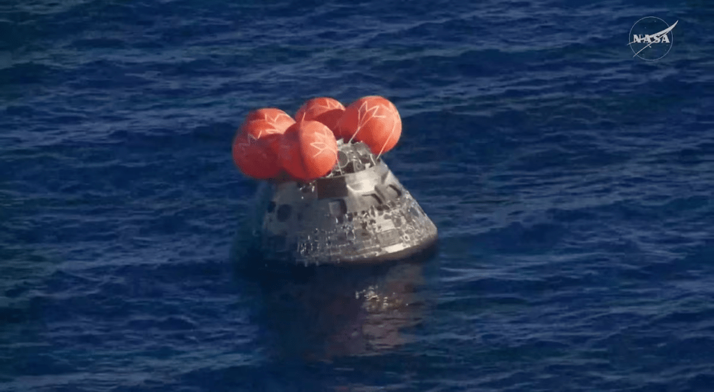 The Artemis II crew capsule floats in the Pacific Ocean following splashdown in this screengrab from a livestream video after the Artemis II crew's flyby of the Moon, April 10, 2026. NASA/Handout via REUTERS 
