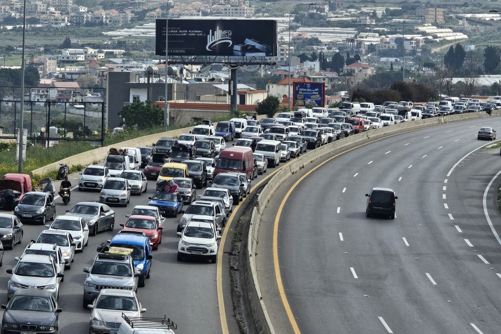 Photo by - / AFP. Displaced residents drive along a highway on the way back to their homes, in Rmeileh at the northern entrance of the Lebanese city of Sidon on April 17, 2026.