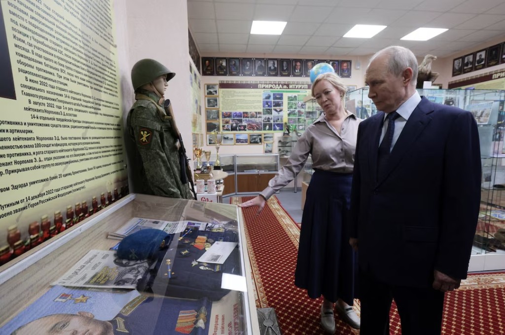  Russian President Vladimir Putin, accompanied by Sakhalin region Minister of Education Anastasia Kikteva, tours a museum of a local school during his visit on the Southern Kuril Island of Iturup, in far eastern Sakhalin Region, Russia, August 13, 2026. Sputnik/Gavriil Grigorov/Pool via REUTERS