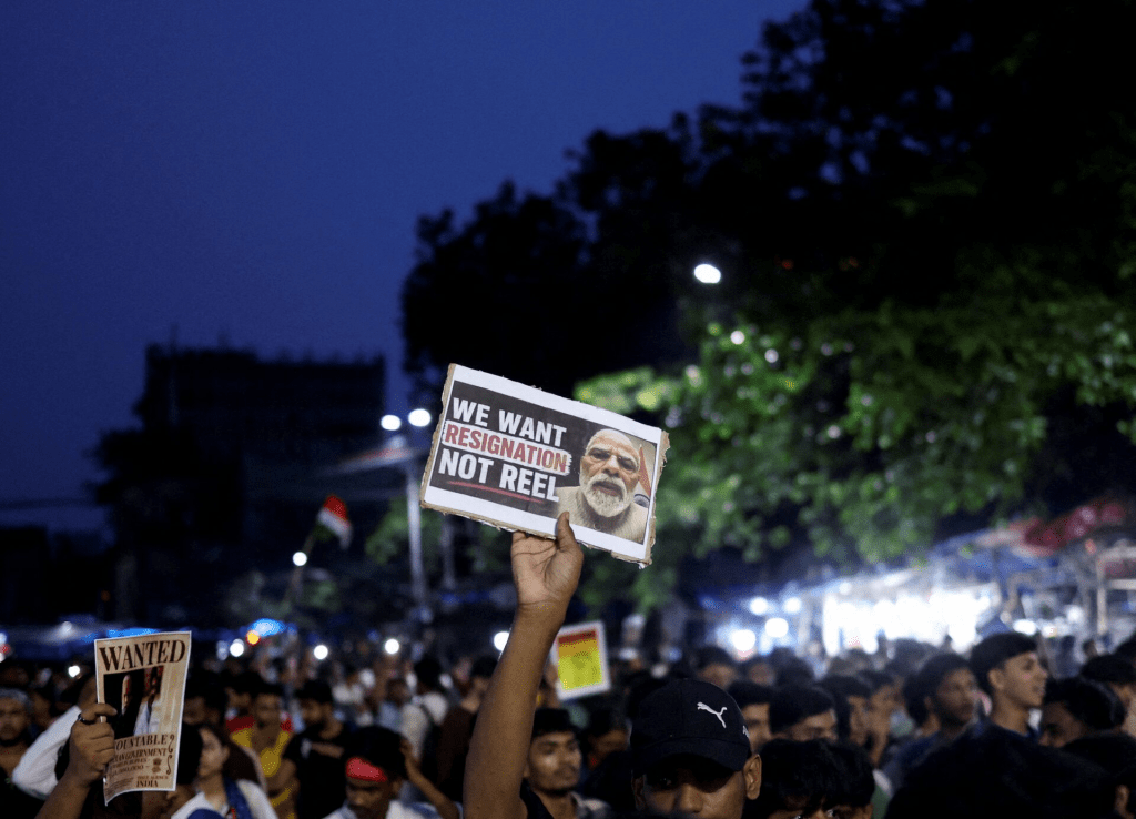 A man holds a poster as he participates in a demonstration held in solidarity with Cockroach Janta Party (CJP) protests held at Jantar Mantar in New Delhi, which demand the resignation of India's Education Minister Dharmendra Pradhan over exam paper leaks, in Kolkata, India, July 24, 2026. REUTERS/Sahiba Chawdhary 