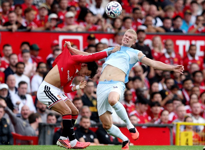 City goalscorer Erling Haaland fights for the ball with United defender Lisandro Martinez. REUTERS