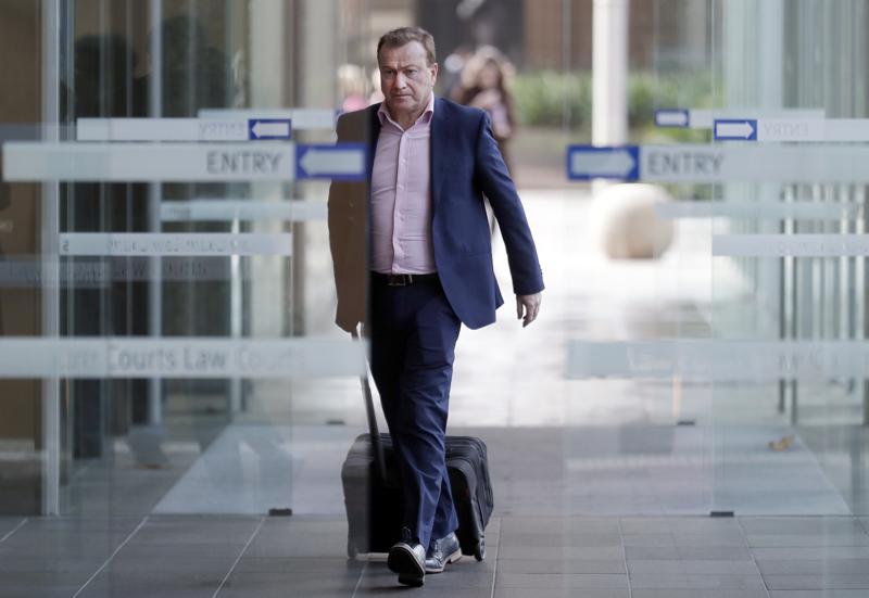 In this May 6, 2021, file photo, Andrew Cooper, founder and president of libertarian group LibertyWorks, arrives at Federal Court in Sydney. An Australian court on Tuesday, June 1, 2021, has rejected a challenge to the federal government's draconian power to prevent most citizens from leaving the country so that they don't bring the coronavirus disease home. In this May 6, 2021, file photo, Andrew Cooper, founder and president of libertarian group LibertyWorks, arrives at Federal Court in Sydney. An Australian court on Tuesday, June 1, 2021, has rejected a challenge to the federal government's draconian power to prevent most citizens from leaving the country so that they don't bring the coronavirus disease home.