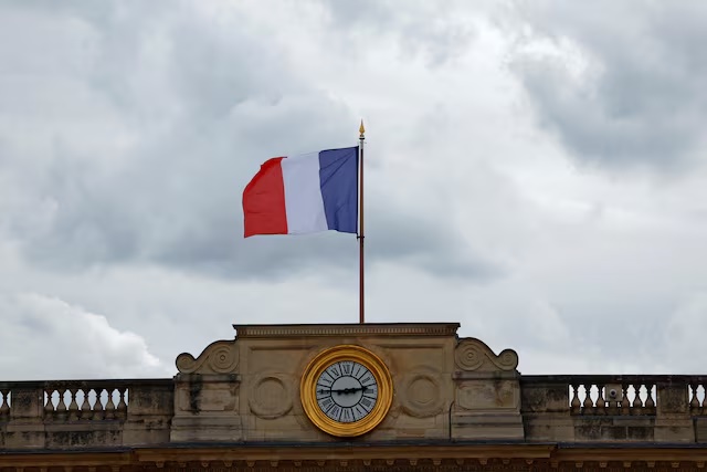 A French flag flies above the National Assembly in Paris on day after the second round of the early French parliamentary elections, France, July 8, 2024. REUTERS/Gonzalo Fuentes/File Photo