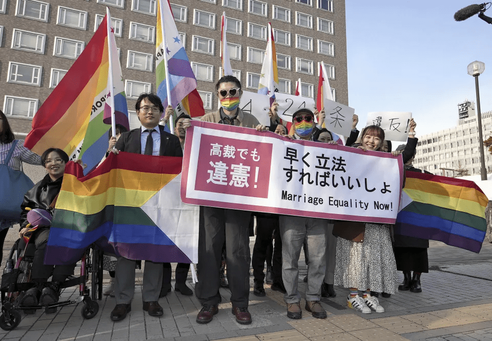 Plaintiffs and others show a banner in front of Sapporo Hight Court in Sapporo, Hokkaido, northern Japan Thursday, March 14, 2024. A banner reads ' Unconstitutional judgment by high court, too. Marriage Equality Now.' The Sapporo High Court ruling said that not allowing same-sex couples to marry and enjoy the same benefits as straight couples violates their fundamental right to have a family. (Kyodo News via AP) Plaintiffs and others show a banner in front of Sapporo Hight Court in Sapporo, Hokkaido, northern Japan Thursday, March 14, 2024. A banner reads ' Unconstitutional judgment by high court, too. Marriage Equality Now.' The Sapporo High Court ruling said that not allowing same-sex couples to marry and enjoy the same benefits as straight couples violates their fundamental right to have a family. (Kyodo News via AP)