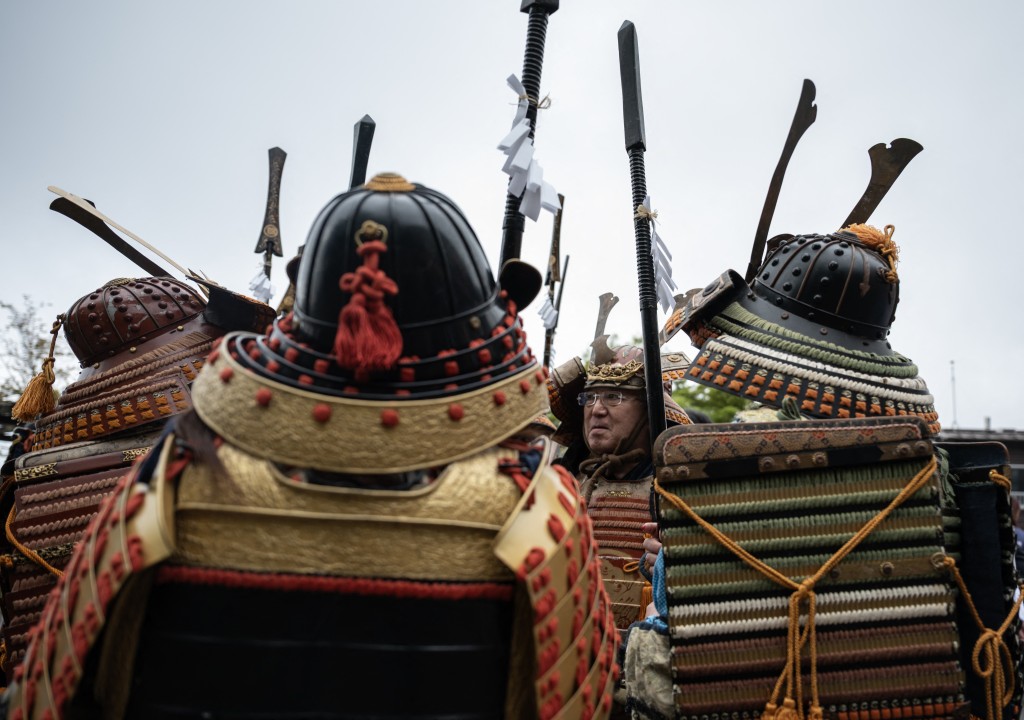 Photo by ANDREW CABALLERO-REYNOLDS / AFP  Participants dressed as a Samurai warriors look on before the start of the second day of the two-day Hinode Sai, or Sunrise festival in Ome, Tokyo Prefecture on April 29, 2026.