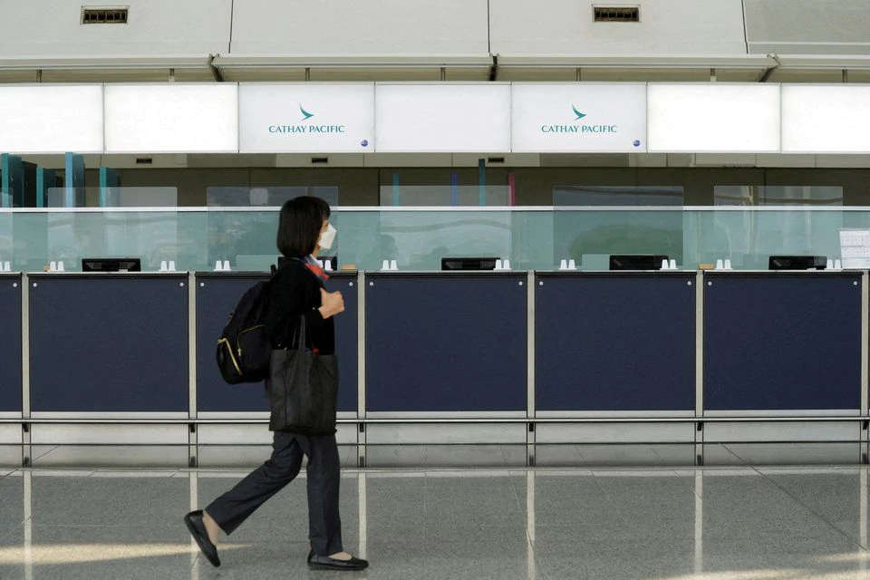 A woman walks past empty counters of Cathay Pacific at Hong Kong International Airport. (Reuters) A woman walks past empty counters of Cathay Pacific at Hong Kong International Airport. (Reuters)