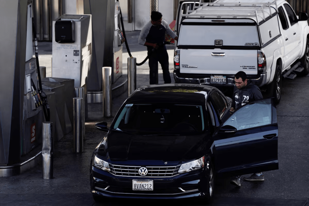 People refuel their vehicles with gasoline at the Helios House, in West Olympic Boulevard in Los Angeles, California, U.S., March 10, 2022. Picture taken March 10, 2022. REUTERS/Bing Guan