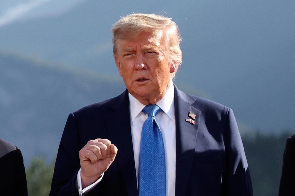 U.S. President Donald Trump gestures as he attends a family photo session during the G7 Summit, in Kananaskis, Alberta, Monday, June 16, 2025. (Suzanne Plunkett/Pool Photo via AP)