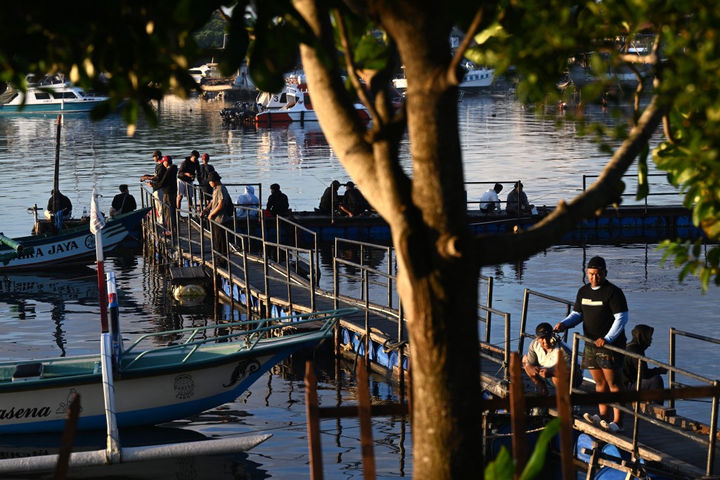 People fish at a pier near Denpasar on Indonesia's resort island of Bali on April 12, 2026. (AFP)