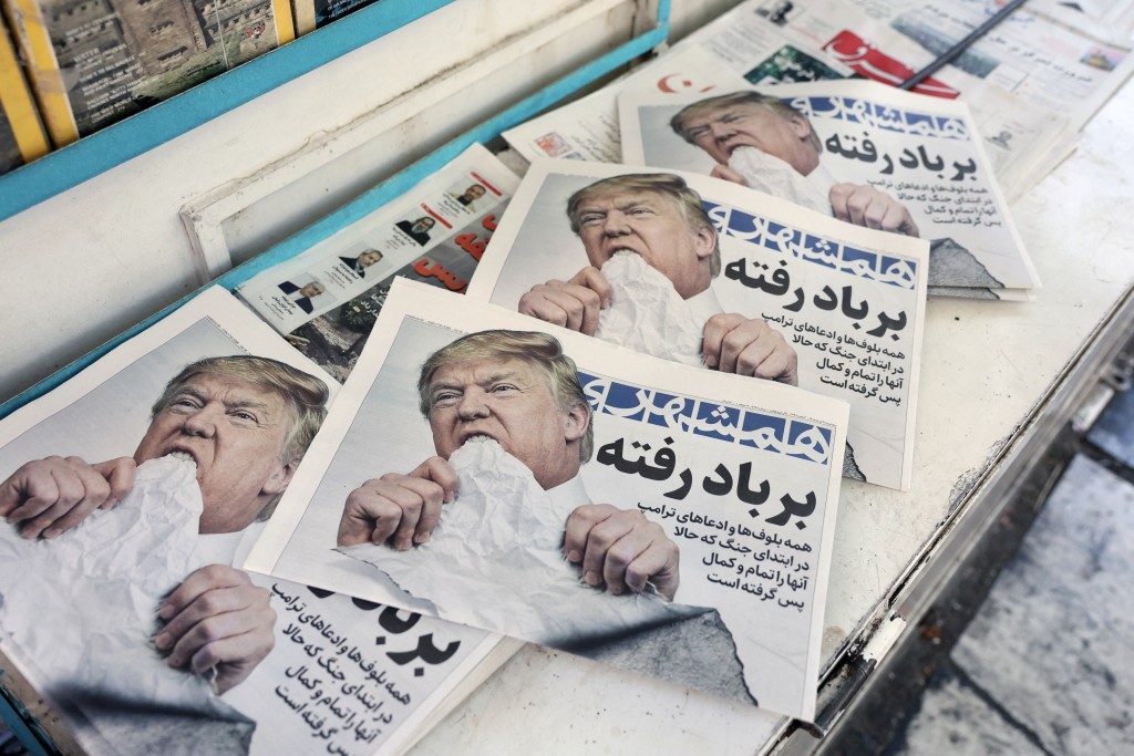 Photo by - / AFP. Copies of the Iranian daily newspaper Hamshahri bearing an image of the US president and a headline that reads "Gone with the wind" are displayed at a kiosk in Tehran on June 18, 2026.