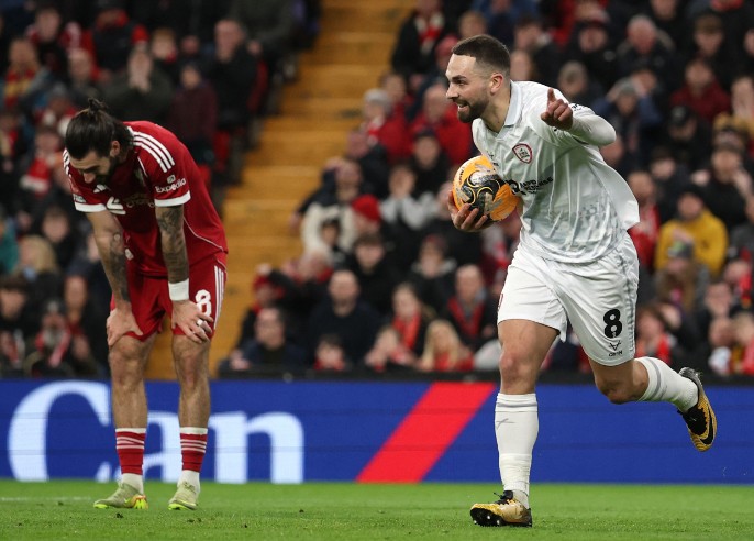 Liverpool's Dominik Szoboszlai, left, reacts after gifting Barnsley's Adam Phillips a goal.  REUTERS