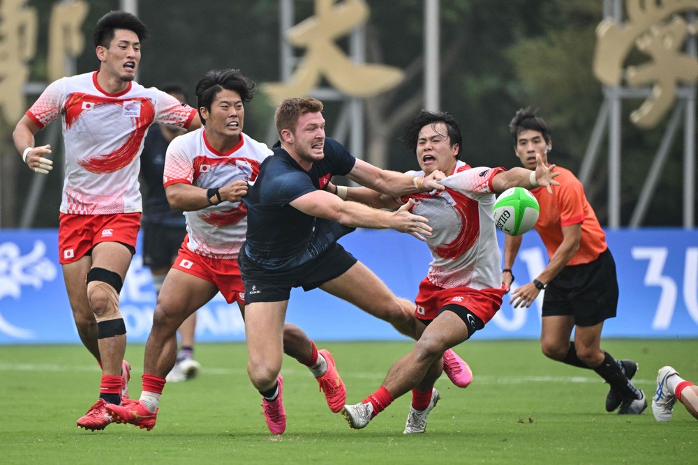 Liam Herbert fights for the ball during the rugby sevens semi-final against Japan. Hong Kong go on to win gold. AFP