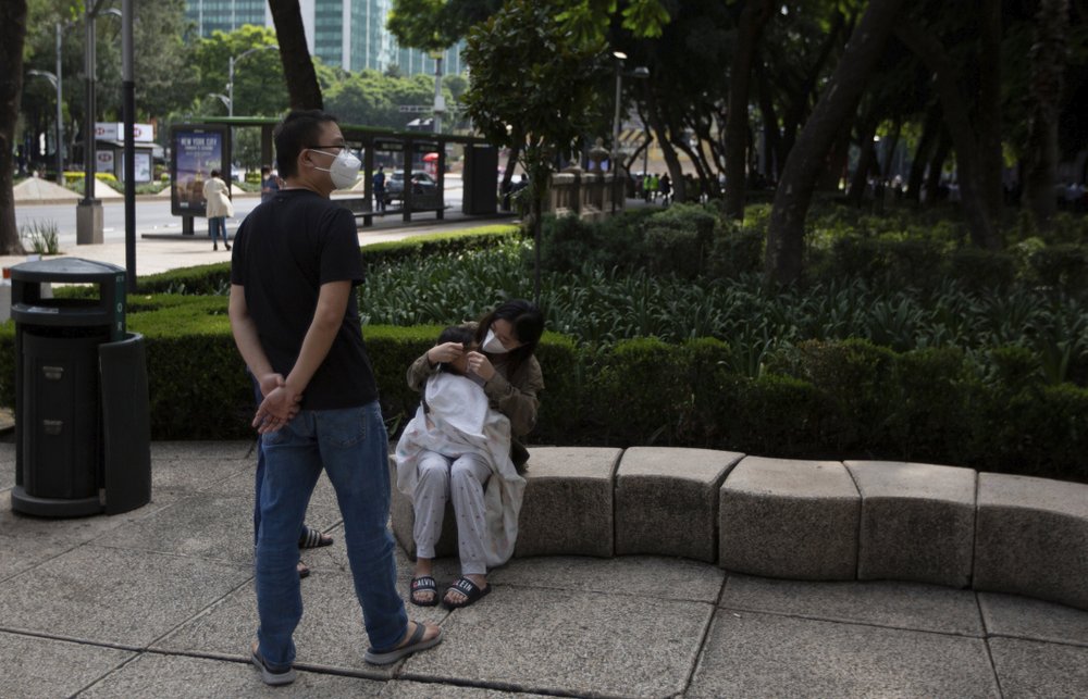 A woman comforts her son after being evacuated from a building during a 7.5 earthquake, in Mexico City, Tuesday, June 23. A woman comforts her son after being evacuated from a building during a 7.5 earthquake, in Mexico City, Tuesday, June 23.