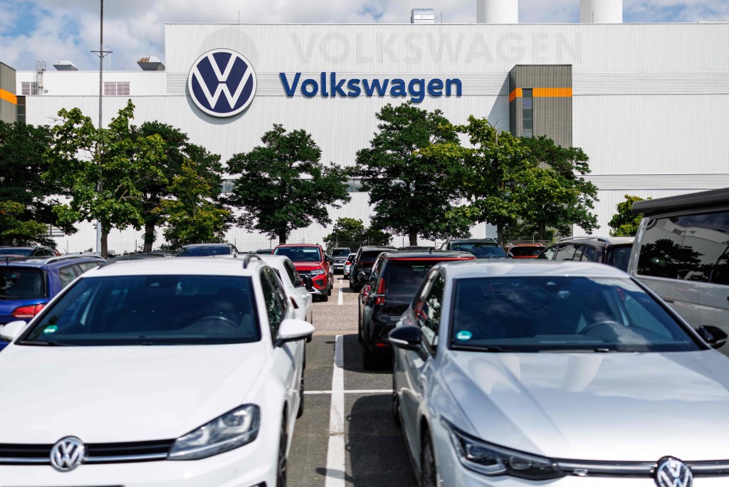 Cars are parked in front of the Zwickau Volkswagen Plant on July 9, 2026 at the Zwickau, eastern Germany. Volkswagen workers staged protests nationwide on July 9 as unions warned of "major conflict" if the struggling German car giant pushes ahead with what could be the global auto industry's biggest restructuring. (Photo by Jens SCHLER / AFP)