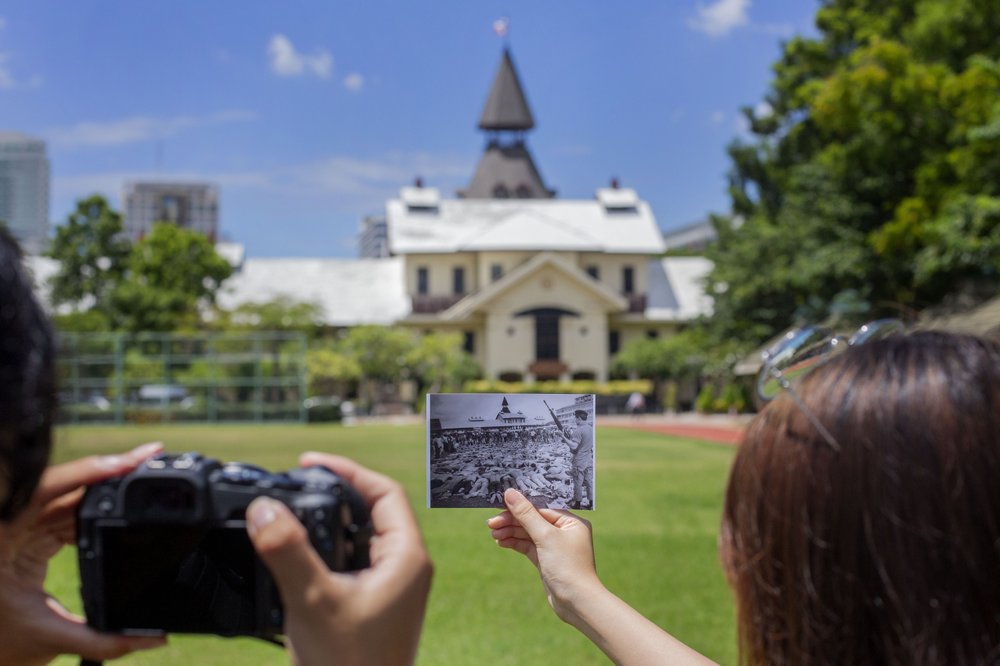 University students compare visual scenes of now and then with historic photographs taken during a student massacre over 40 years ago at the Thammasat University, in Bangkok Thursday, October 1. University students compare visual scenes of now and then with historic photographs taken during a student massacre over 40 years ago at the Thammasat University, in Bangkok Thursday, October 1.