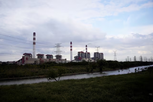 Electricity pylons stand in front of a coal-fired power plant in Shanghai, China October 21, 2021. (Reuters)