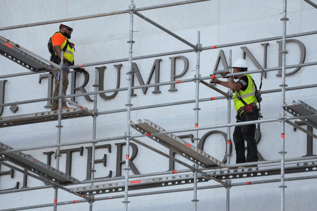 Workers prepare to remove lettering from the facade of the John F. Kennedy Memorial Center for the Performing Arts, following a federal judge’s order to remove U.S. President Donald Trump's name from the institution, in Washington, D.C., U.S., June 12, 2026. REUTERS/Ken Cedeno