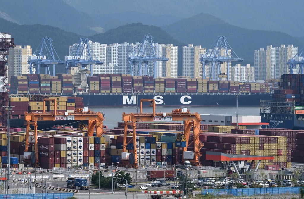 This general view shows containers, cranes and a MSC container ship docked at Busan New Port in Busan on August 22, 2026. (Photo by Jung Yeon-je / AFP)
