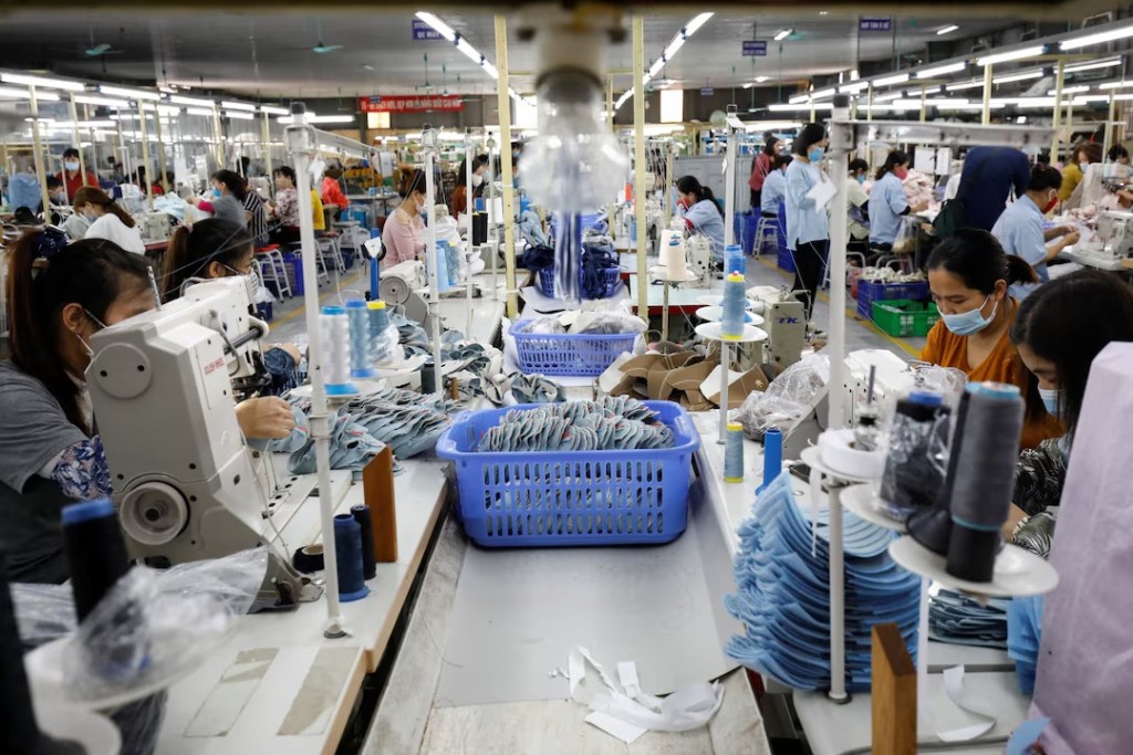 Employees work at a shoe factory for export in Hanoi, Vietnam December 29, 2020. REUTERS/Kham/File Photo