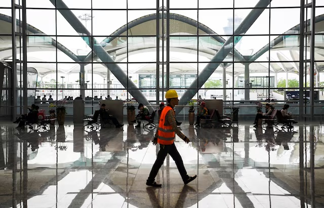 A worker walks at the Terminal 2 of Guangzhou Baiyun International Airport in Guangdong province, China April 20, 2018. China Daily via REUTERS 