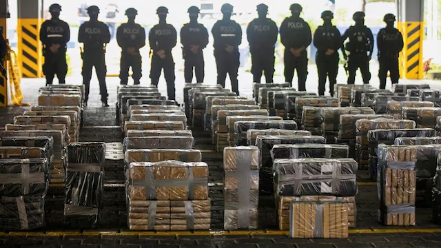 Police officers stand by drug packages displayed to the media following Costa Rican authorities' seizure of over three tons of cocaine hidden in a container of fresh fruit intended for European markets, in San Jose, Costa Rica, June 10, 2025. REUTERS/Maynor Valenzuela