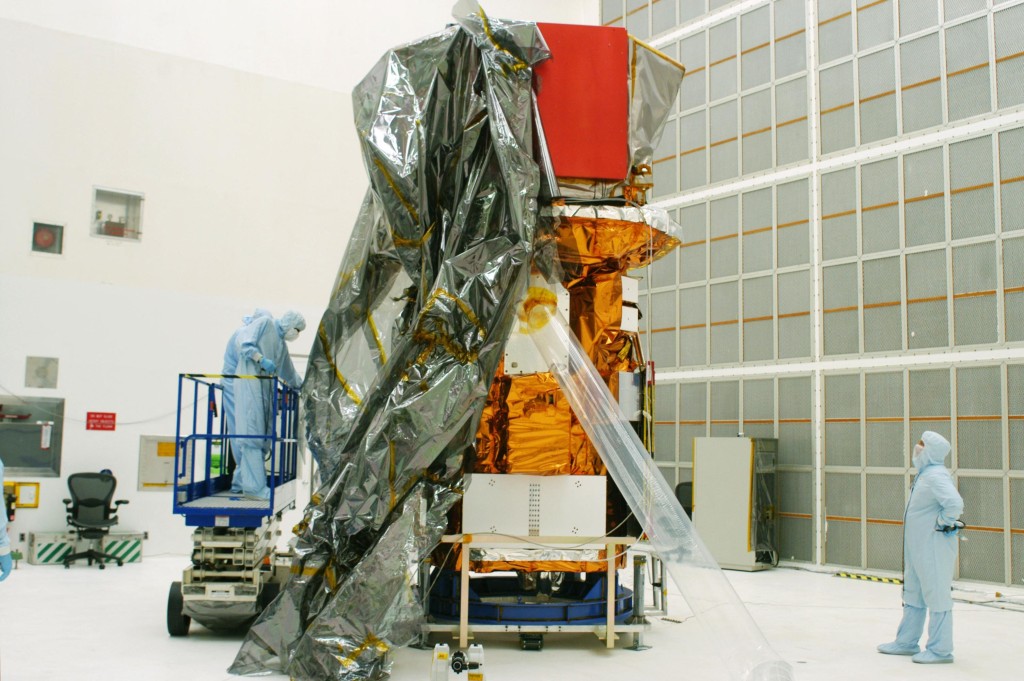 Photo by HANDOUT / NASA / AFP  This handout photo released by NASA on July 31, 2004, shows the Swift spacecraft being unwrapped in Hangar AE at Cape Canaveral Air Force Station at Kennedy Space Center, Florida.