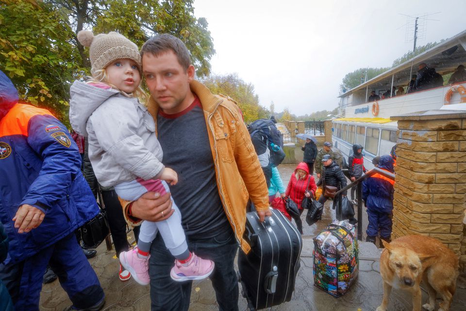 Civilians evacuated from the Russian-controlled city of Kherson walk from a ferry to board a bus heading to Crimea, in the town of Oleshky, Kherson region, Russian-controlled Ukraine October 23, 2022. (REUTERS/Alexander Ermochenko) Civilians evacuated from the Russian-controlled city of Kherson walk from a ferry to board a bus heading to Crimea, in the town of Oleshky, Kherson region, Russian-controlled Ukraine October 23, 2022. (REUTERS/Alexander Ermochenko)