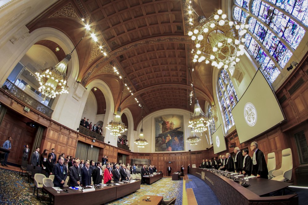 In this Wednesday February 13, 2019, photo, judges enter as the delegations of Iran, front row left, and the U.S., front row rear right, stand up, at the International Court of Justice, or World Court, in The Hague, Netherlands. In this Wednesday February 13, 2019, photo, judges enter as the delegations of Iran, front row left, and the U.S., front row rear right, stand up, at the International Court of Justice, or World Court, in The Hague, Netherlands.