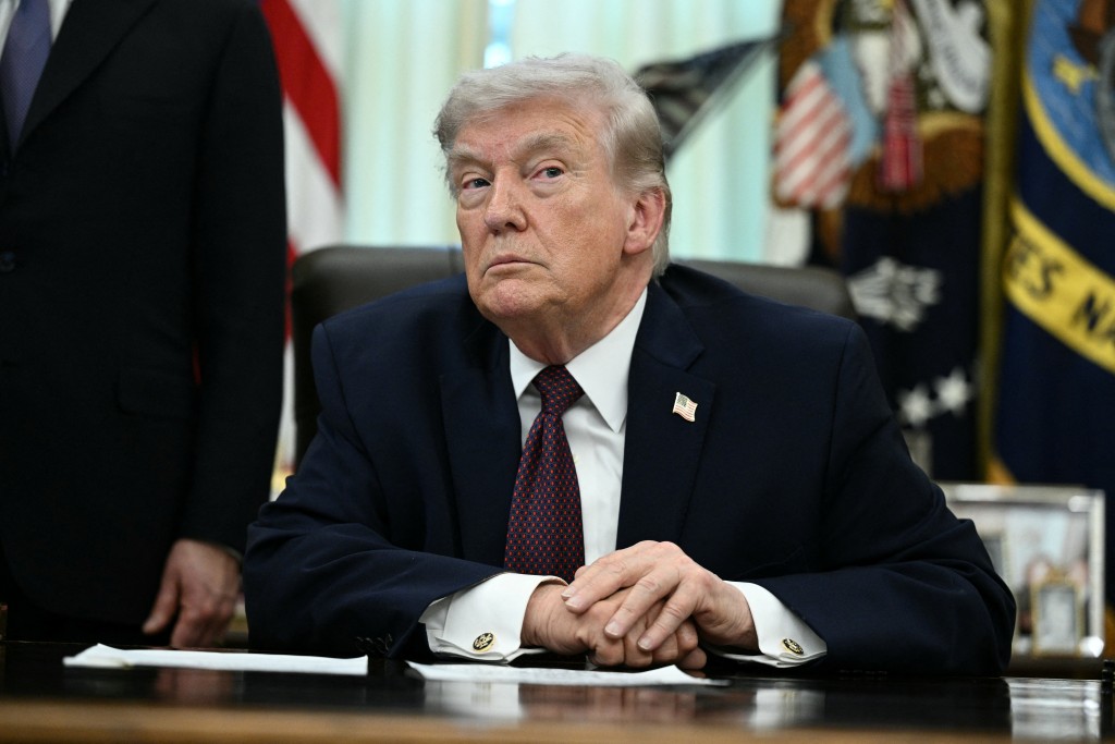 US President Donald Trump takes a question from a reporter after signing an executive order in the Oval Office of the White House in Washington, DC, on March 31, 2026. (Photo by Brendan SMIALOWSKI / AFP)