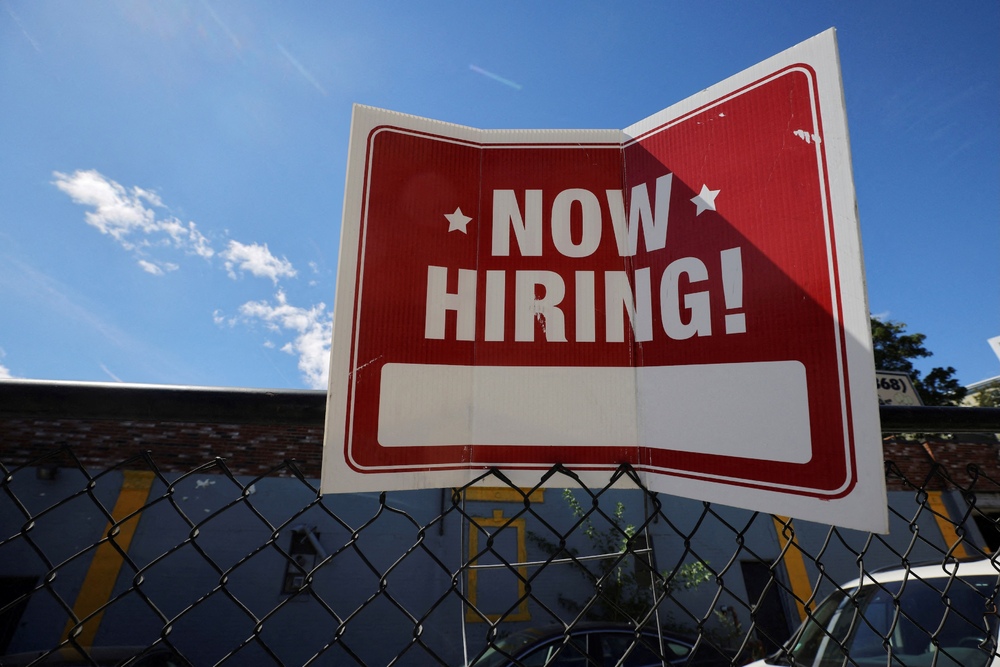 A "now hiring" sign is displayed outside Taylor Party and Equipment Rentals in Somerville, Massachusetts, US, September 1, 2022. REUTERS