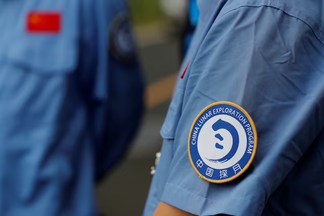 A badge of China Lunar Exploration Program is seen on an employee's uniform at Wenchang Space Launch Center in Hainan Province, China November 23, 2020. REUTERS/Tingshu Wang/File Photo