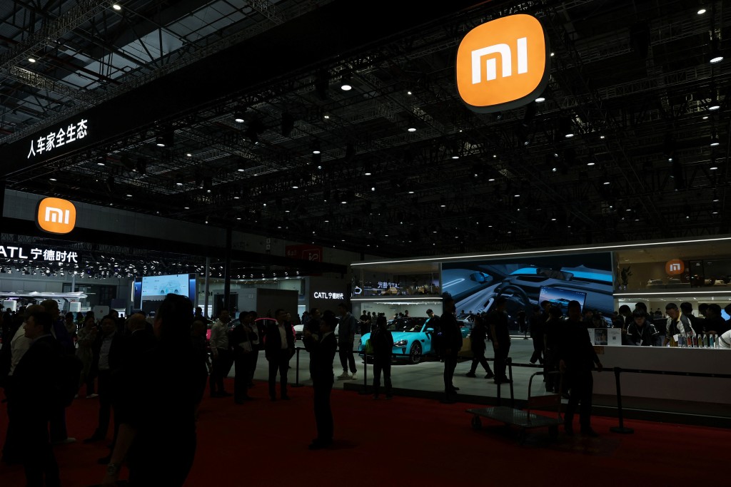 People visit the Xiaomi booth during a media day for the Auto Shanghai show in Shanghai, China April 23, 2025.