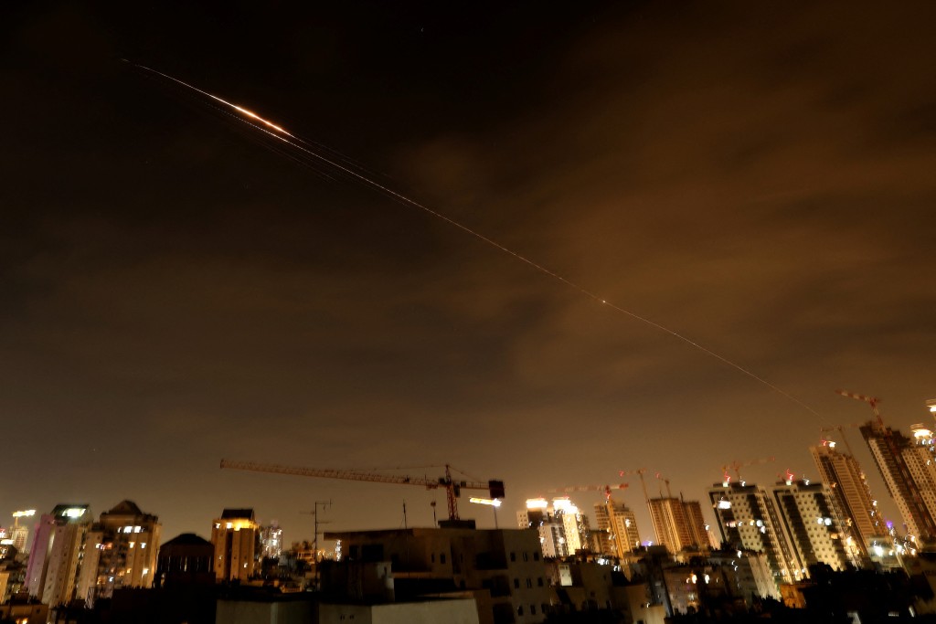 Rocket trails are seen in the sky amid a fresh barrage of Iranian missile attacks above the Israeli coastal city of Netanya on March 23, 2026. (AFP)