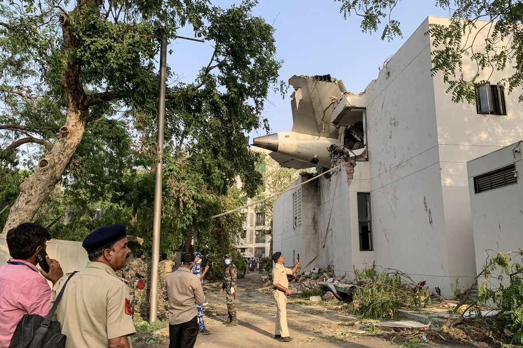 Photo by SAM PANTHAKY / AFP  The back of Air India flight 171 is pictured at the site after it crashed in a residential area near the airport in Ahmedabad on June 12, 2025.