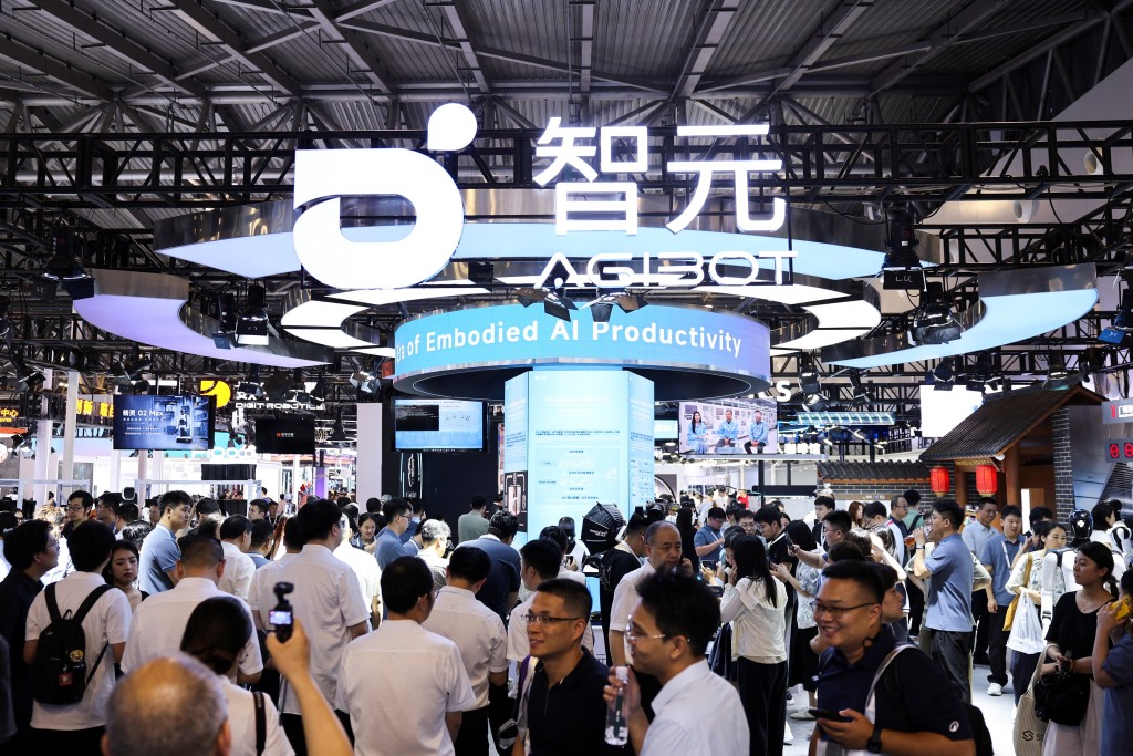 People walk past the Agibot booth during the World Artificial Intelligence Conference (WAIC) in Shanghai, China, July 17, 2026. 
