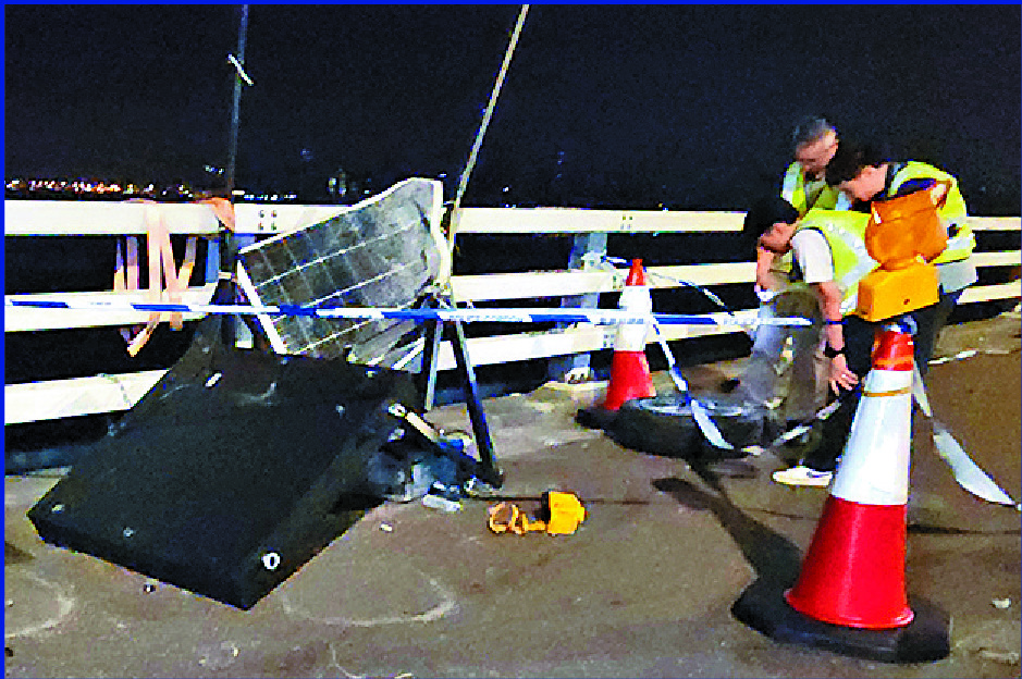 The vehicle reportedly hit a roadside information board, far left, before shooting off the bridge. SING TAO