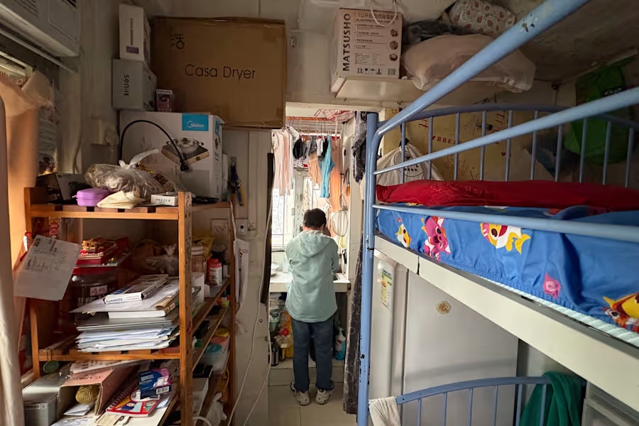 Housewife Jimmy Au stands in her kitchen at home in a residential area of Prince Edward district in Hong Kong on Jan. 21, 2025. (AP Photo/Kanis Leung)