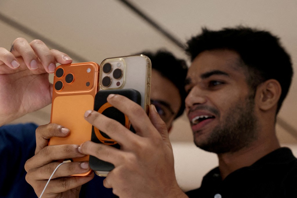 A customer compares his old iPhone with the newly launched iPhone 17 pro max at an Apple retail store in Delhi, India, September 19, 2025. (Reuters/File)