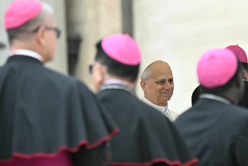 Pope Leo XIV greets bishops during the weekly general audience at St Peter's Square in The Vatican on October 22, 2025. (Photo by Tiziana FABI / AFP)