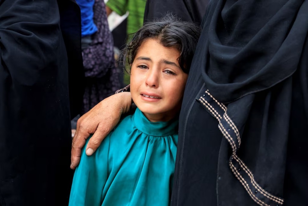 A mourner reacts during the funeral of Palestinians killed in what the Gaza health ministry says was Israeli fire near a distribution center in Rafah, at Nasser Hospital in Khan Younis, in the southern Gaza Strip, June 16, 2025. REUTERS/Hatem Khaled