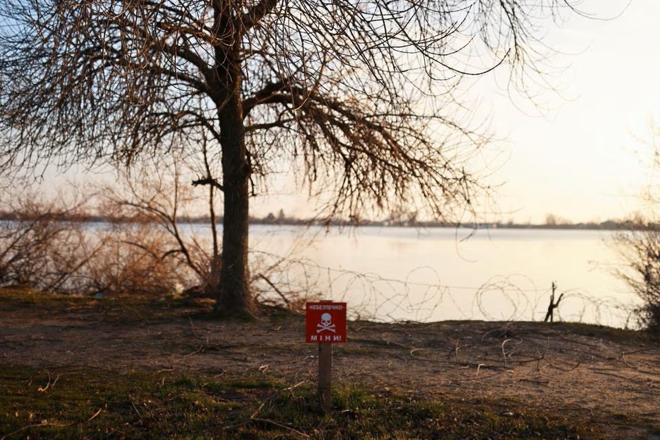 A view of a mine danger sign in front of Dnipro River, amid Russia's invasion of Ukraine, in Kherson, Ukraine. (Reuters) A view of a mine danger sign in front of Dnipro River, amid Russia's invasion of Ukraine, in Kherson, Ukraine. (Reuters)