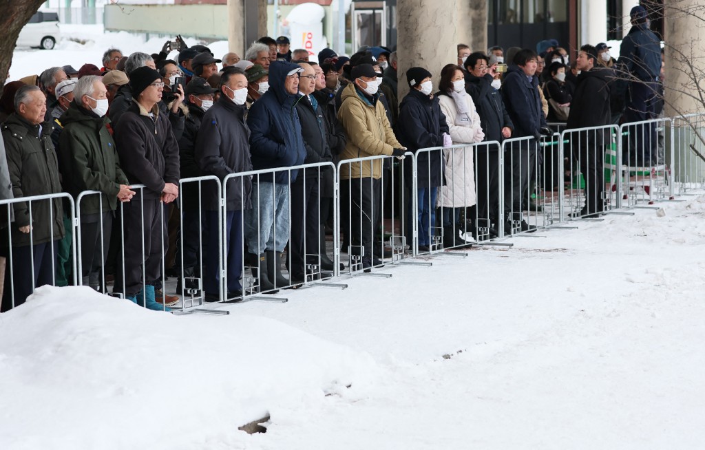 Voters listen to a party leader's speech at a House of Representatives election rally held in a snow-covered venue in Hirosaki, Aomori Prefecture on January 27, 2026. (Photo by JIJI PRESS / AFP) 
