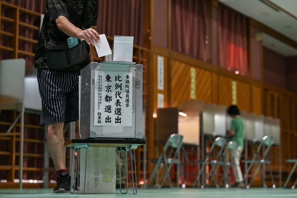 Voters take part in upper house elections at a polling station in Tokyo on July 20, 2025. (AFP)