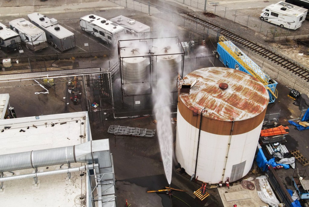 A drone view shows water being sprayed during a chemical incident involving a leaking tank of methyl methacrylate, a flammable liquid used in the aerospace industry, forcing an evacuation in the surrounding area, in Garden Grove, California, U.S., May 23, 2026. (Reuters)