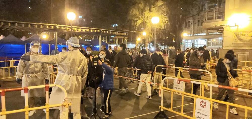 Residents of Block 3 of Po Tin Estate in Tuen Mun line up to undergo compulsory testing. 